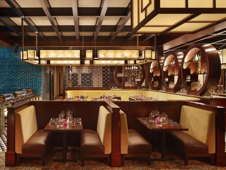 Booths and tables alike glow under Mystique Asian Restaurants Kofu Oblong Pendants, which square the entire length of the lounge.